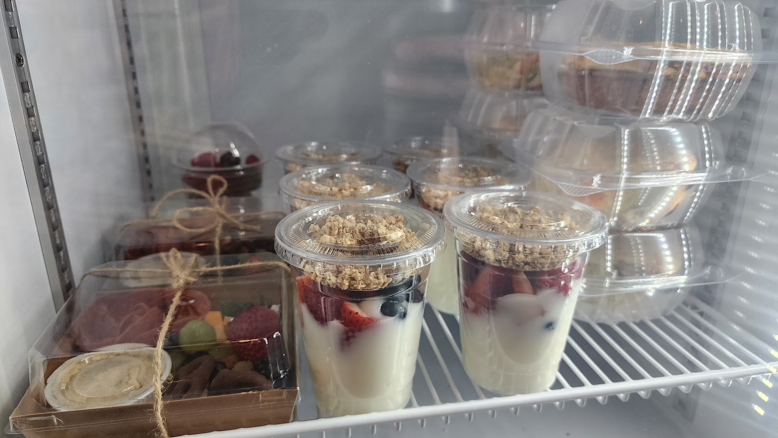 Yogurt parfaits and charcuterie cups in the display case